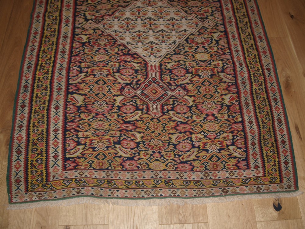 ANTIQUE SENNEH KILIM WITH MEDALLION DESIGN, SOFT COLOURS, CIRCA 1900. View V
