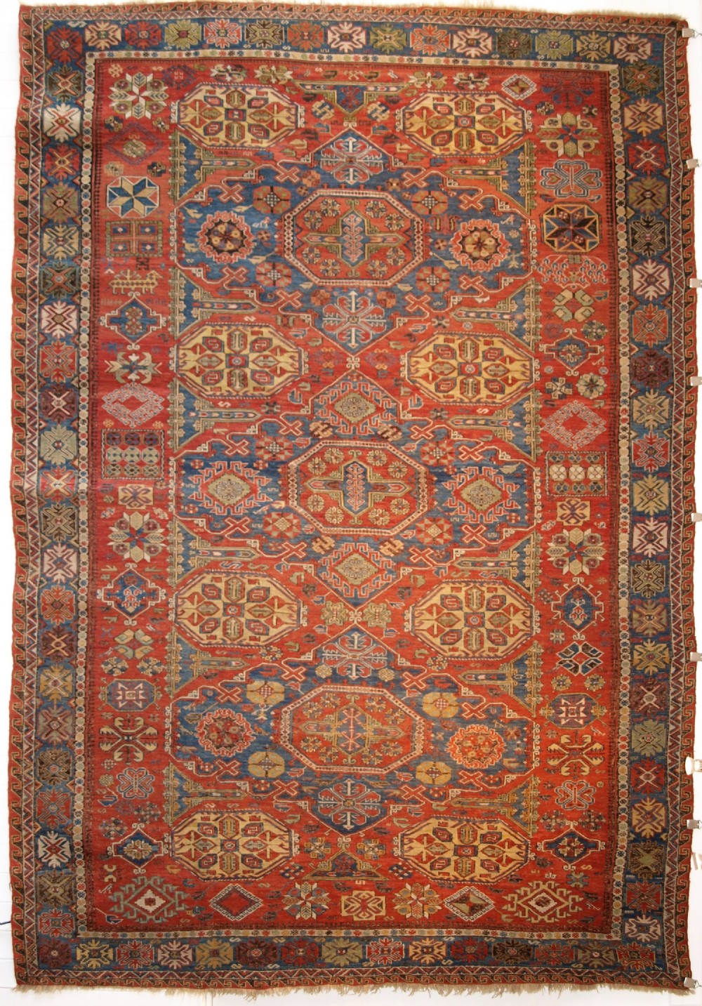 ANTIQUE CAUCASIAN THREE MEDALLION SOUMAK CARPET OF RARE DESIGN, SUPERB COLOUR, CIRCA 1880.