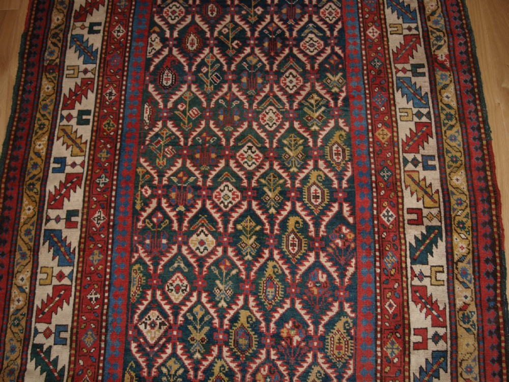 ANTIQUE CAUCASIAN DAGHESTAN RUG WITH SCARCE GREEN GROUND, LATTICE DESIGN, CIRCA 1880. View V