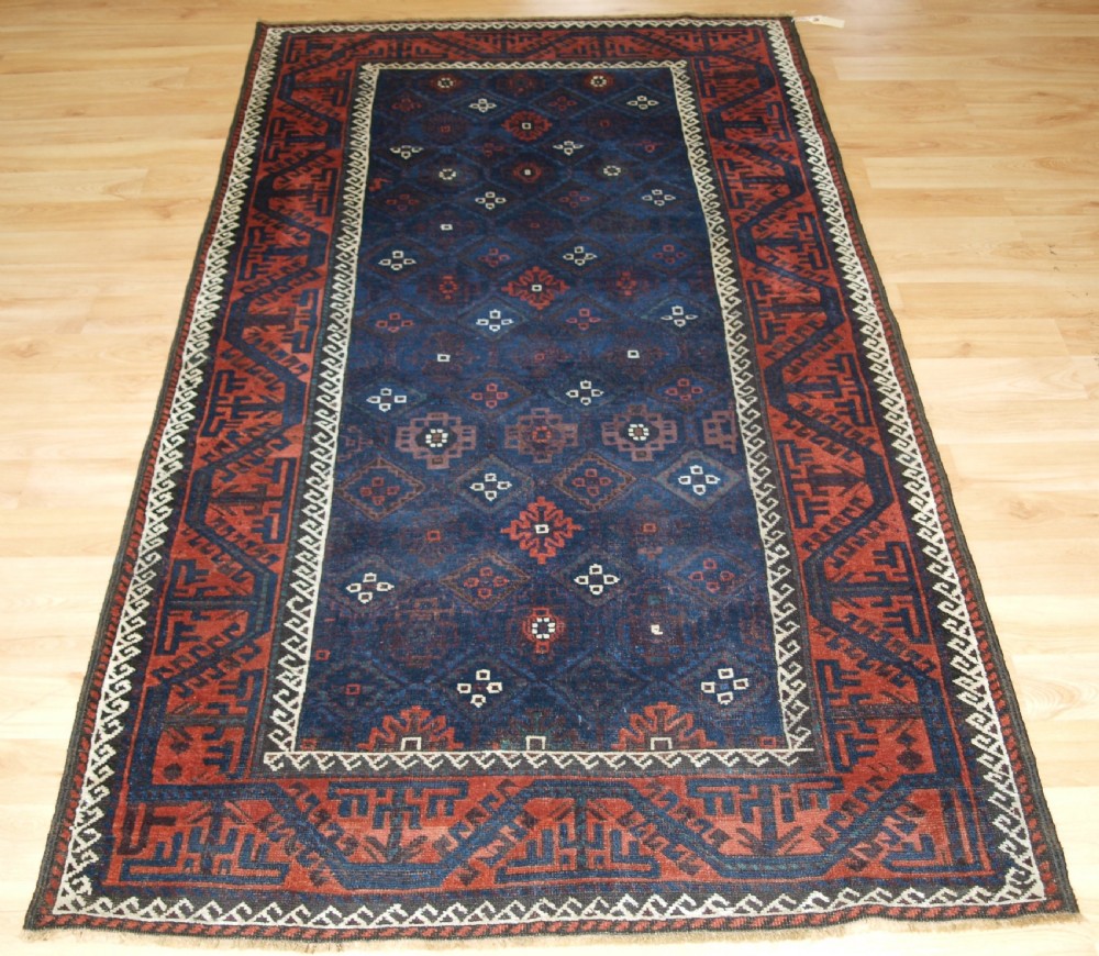 ANTIQUE BALUCH RUG WITH LATTICE DESIGN IN SUPERB BLUES, BOAT BORDER, LATE 19TH CENTURY.
