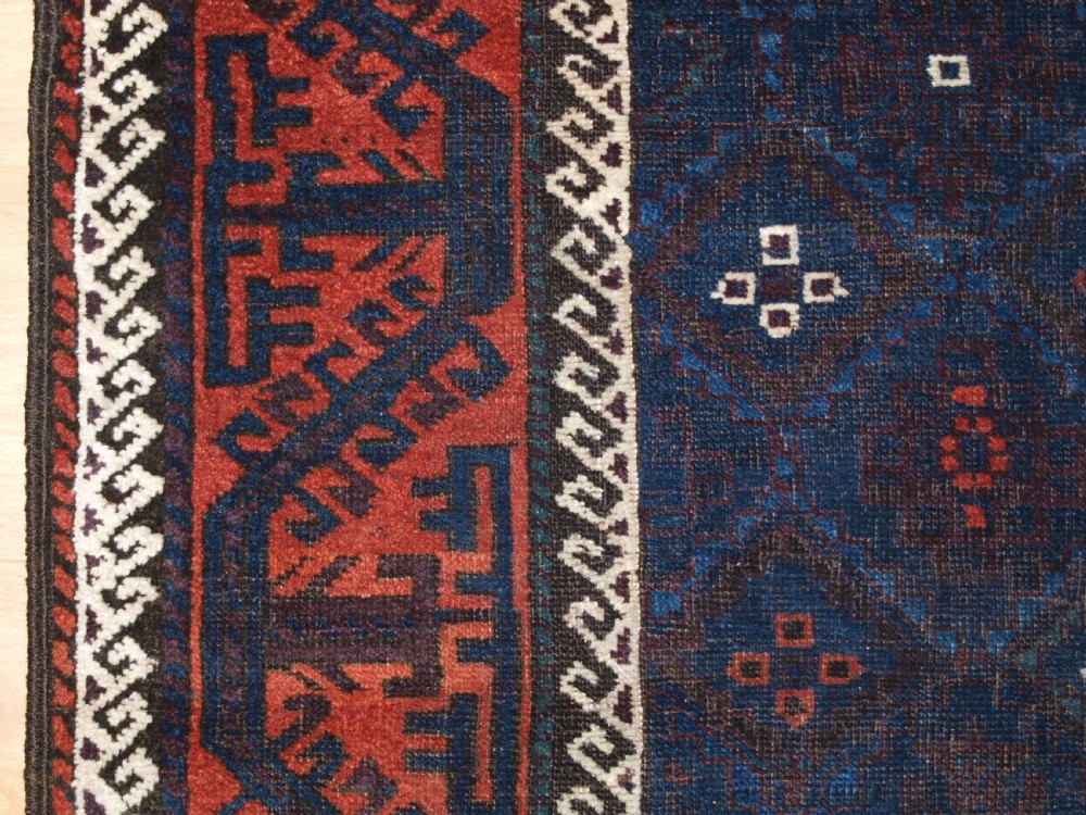 ANTIQUE BALUCH RUG WITH LATTICE DESIGN IN SUPERB BLUES, BOAT BORDER, LATE 19TH CENTURY. View IV