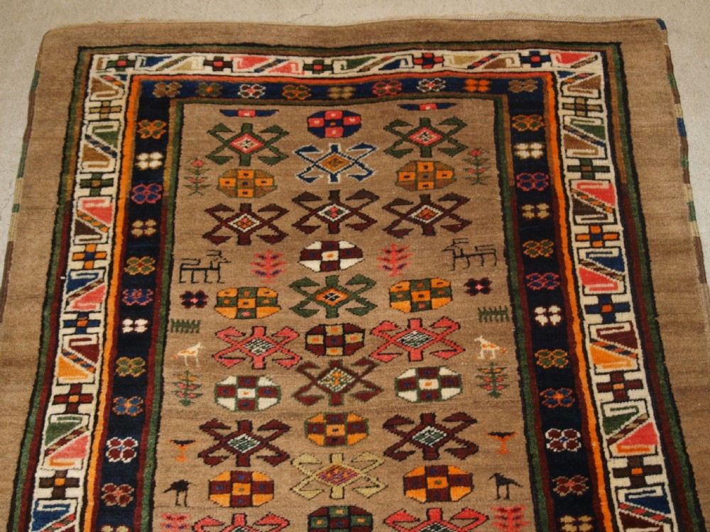 ANTIQUE SARAB RUNNER, CAMEL WOOL GROUND WITH ANIMALS, CIRCA 1900. View IV
