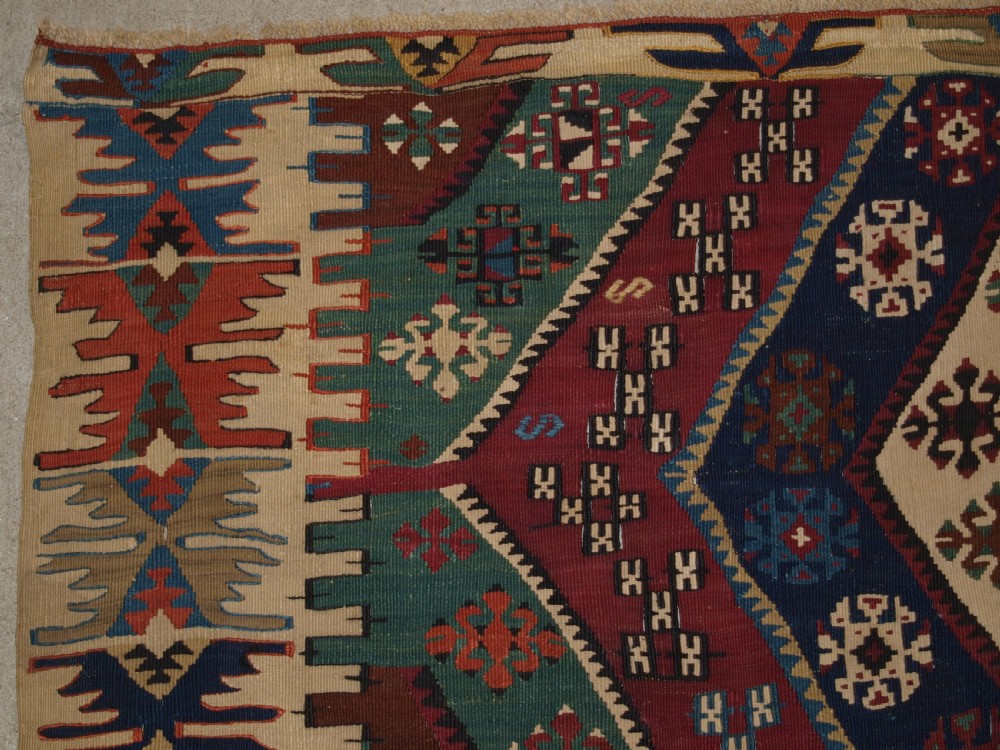 A large flatwoven late 19th-century Turkish Malatya kilim rug with central geometric diamond medallions in red, blue, green, and cream wool. View II