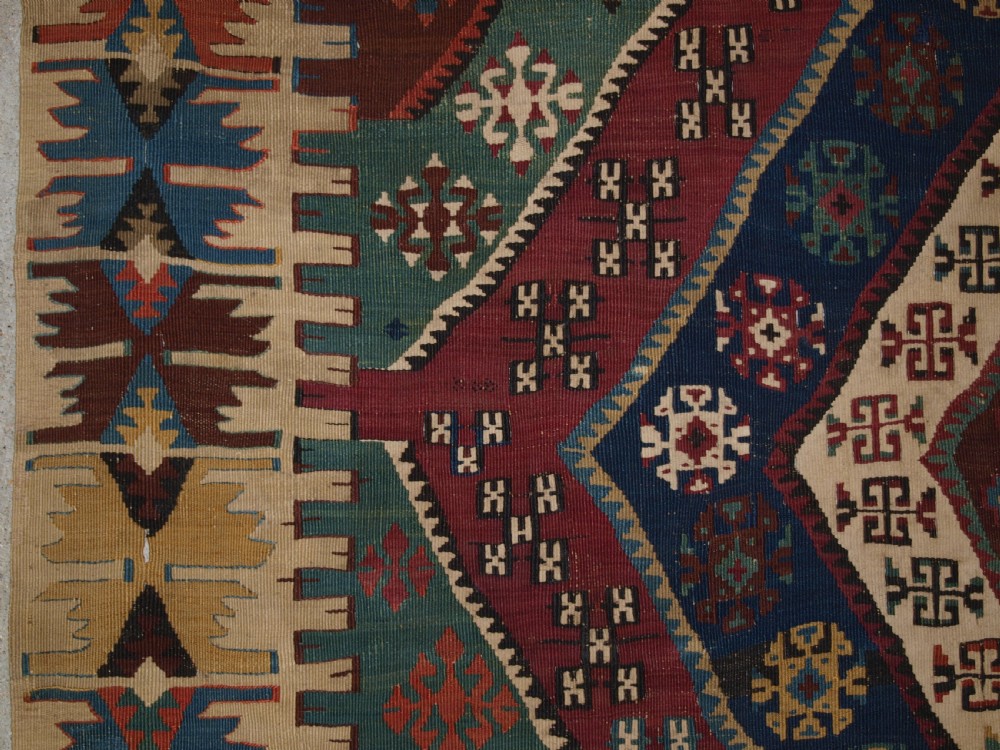 A large flatwoven late 19th-century Turkish Malatya kilim rug with central geometric diamond medallions in red, blue, green, and cream wool. View III