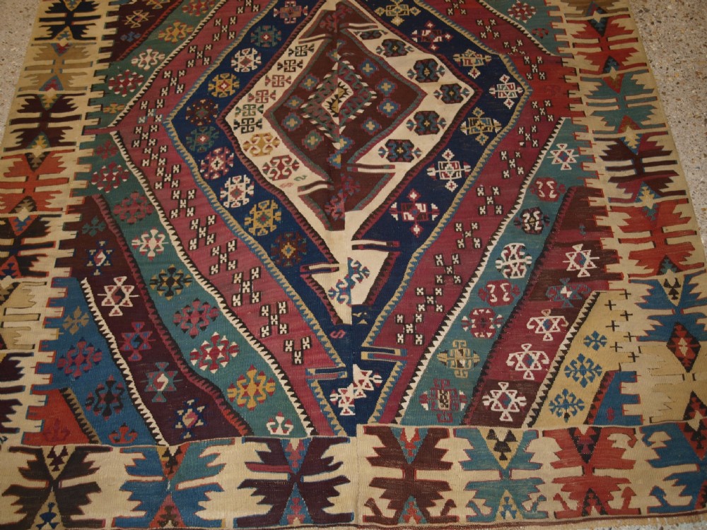 A large flatwoven late 19th-century Turkish Malatya kilim rug with central geometric diamond medallions in red, blue, green, and cream wool. View VIII