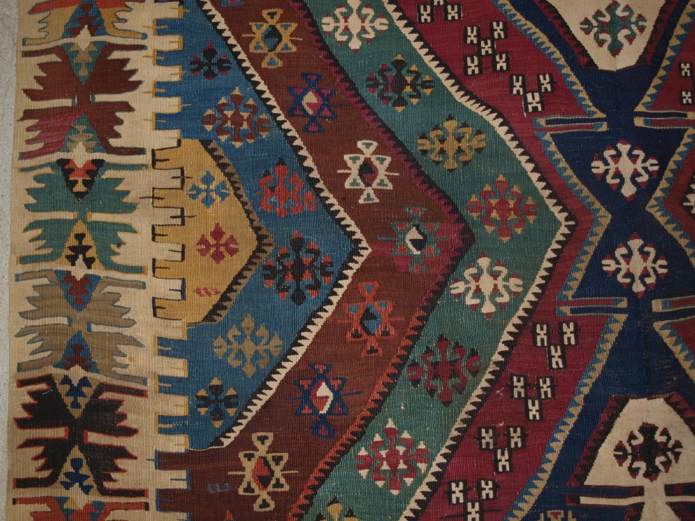 A large flatwoven late 19th-century Turkish Malatya kilim rug with central geometric diamond medallions in red, blue, green, and cream wool. View IX