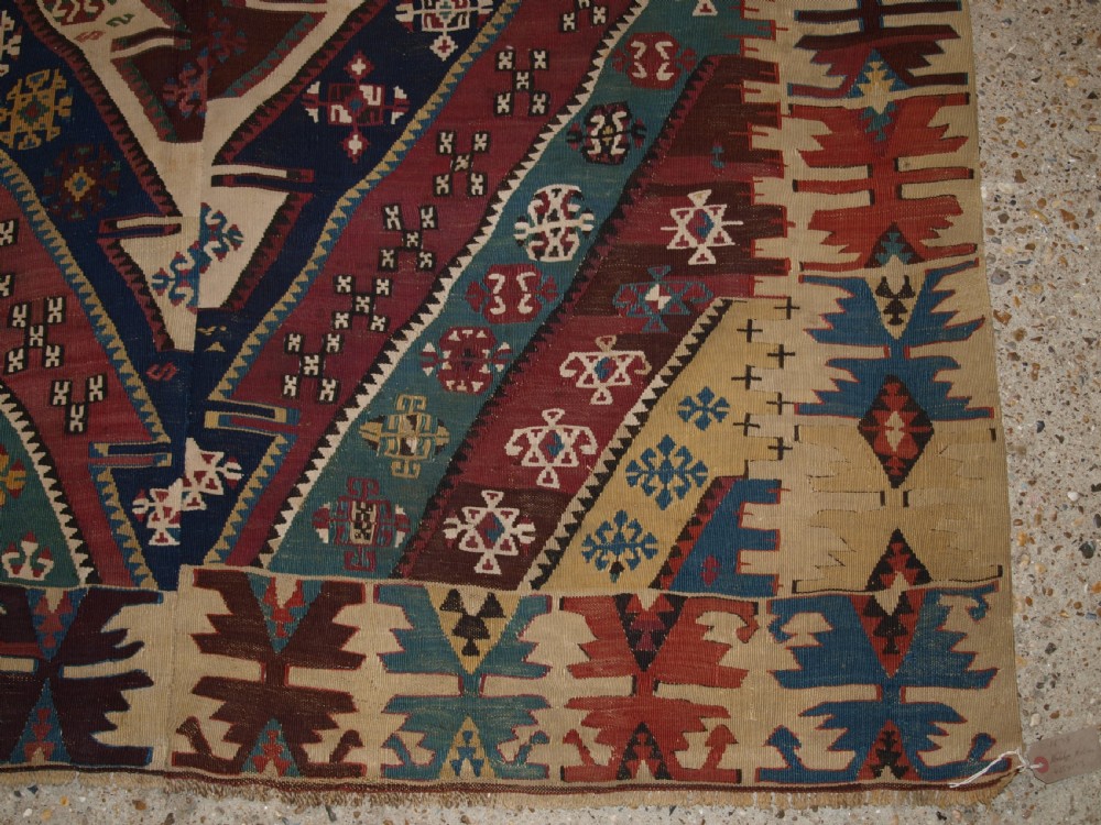 A large flatwoven late 19th-century Turkish Malatya kilim rug with central geometric diamond medallions in red, blue, green, and cream wool. View XI