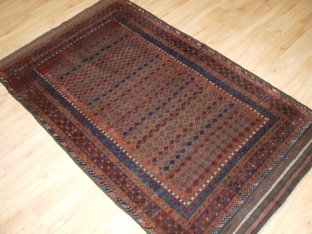 ANTIQUE BALUCH RUG WITH REPEAT DESIGN, COMPLETE KILIM ENDS, CIRCA 1900. View II