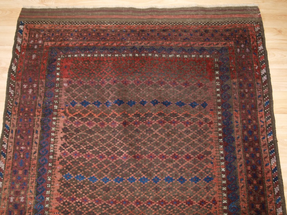 ANTIQUE BALUCH RUG WITH REPEAT DESIGN, COMPLETE KILIM ENDS, CIRCA 1900. View IV