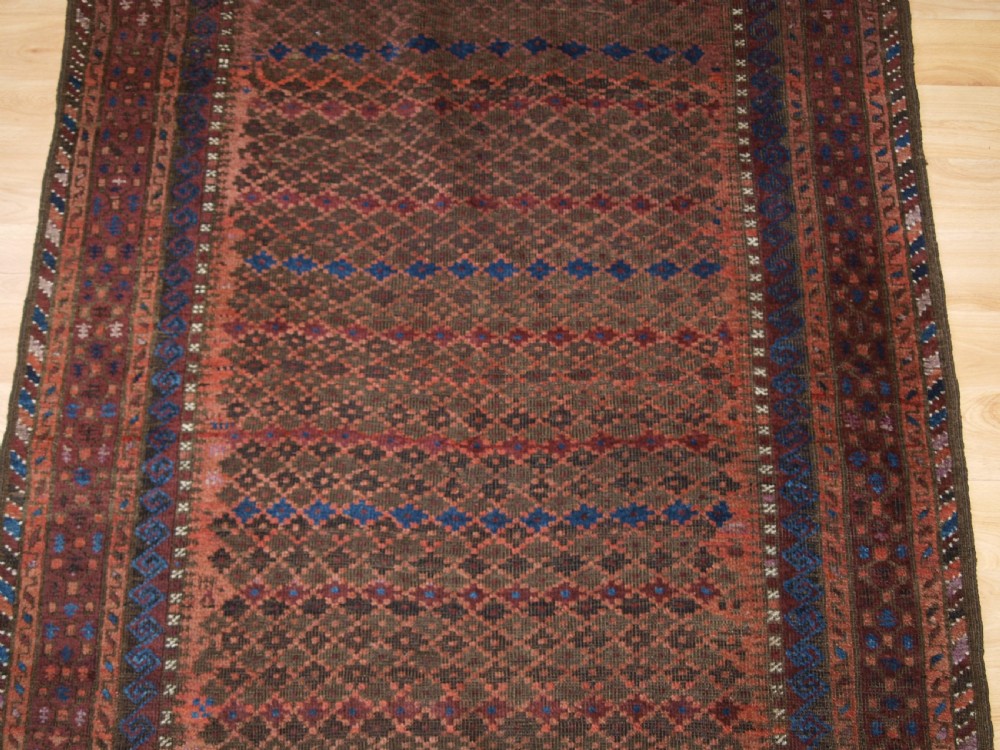 ANTIQUE BALUCH RUG WITH REPEAT DESIGN, COMPLETE KILIM ENDS, CIRCA 1900. View V