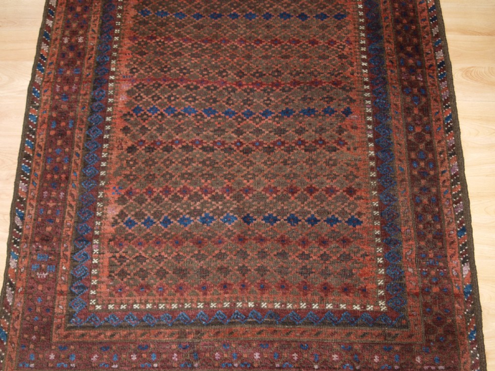 ANTIQUE BALUCH RUG WITH REPEAT DESIGN, COMPLETE KILIM ENDS, CIRCA 1900. View VI