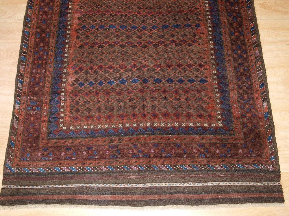 ANTIQUE BALUCH RUG WITH REPEAT DESIGN, COMPLETE KILIM ENDS, CIRCA 1900. View VIII