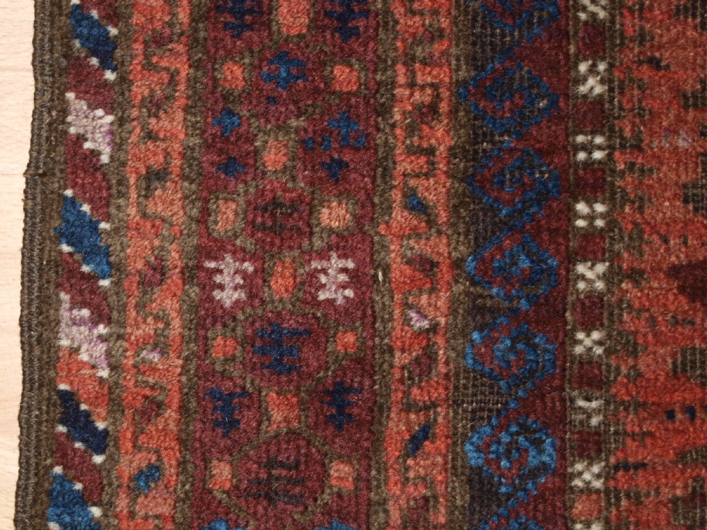 ANTIQUE BALUCH RUG WITH REPEAT DESIGN, COMPLETE KILIM ENDS, CIRCA 1900. View IX