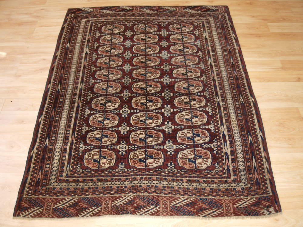 ANTIQUE TEKKE TURKMEN RUG OF SMALL SIZE, RICH RED BROWN COLOUR, CIRCA 1900.