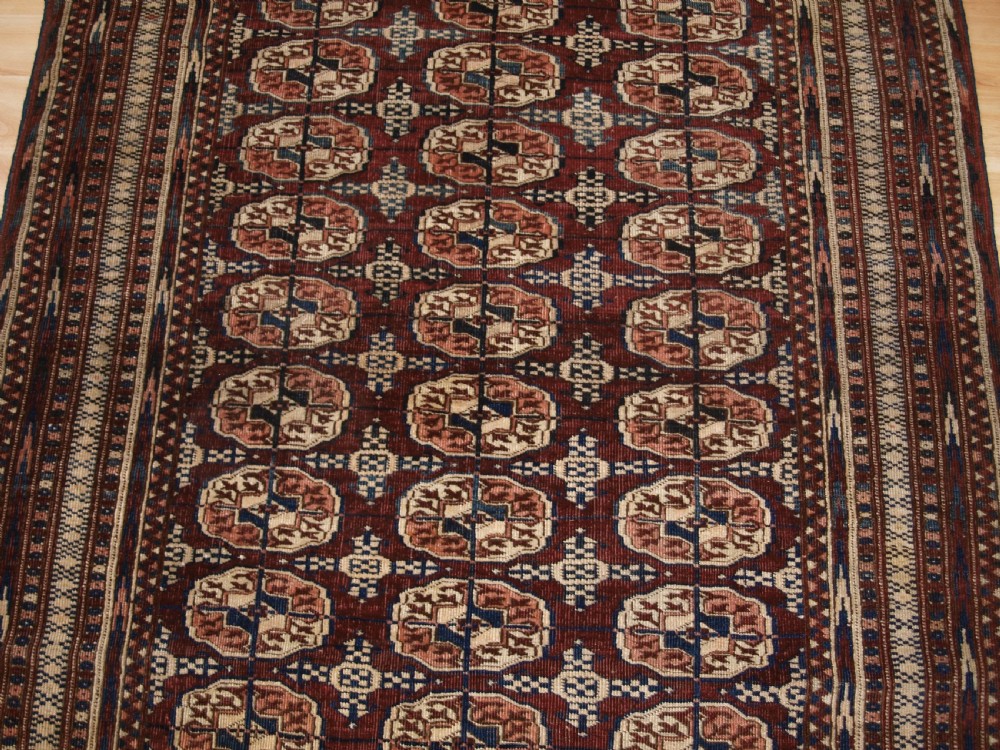 ANTIQUE TEKKE TURKMEN RUG OF SMALL SIZE, RICH RED BROWN COLOUR, CIRCA 1900. View V