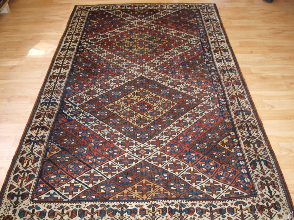 ANTIQUE KURDISH RUG WITH LATTICE DESIGN, VISUALLY STRIKING RUG, CIRCA 1900.