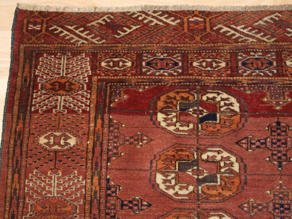 ANTIQUE TEKKE TURKMEN RUG WITH ABRASHED MADDER RED FIELD, CIRCA 1900. View III
