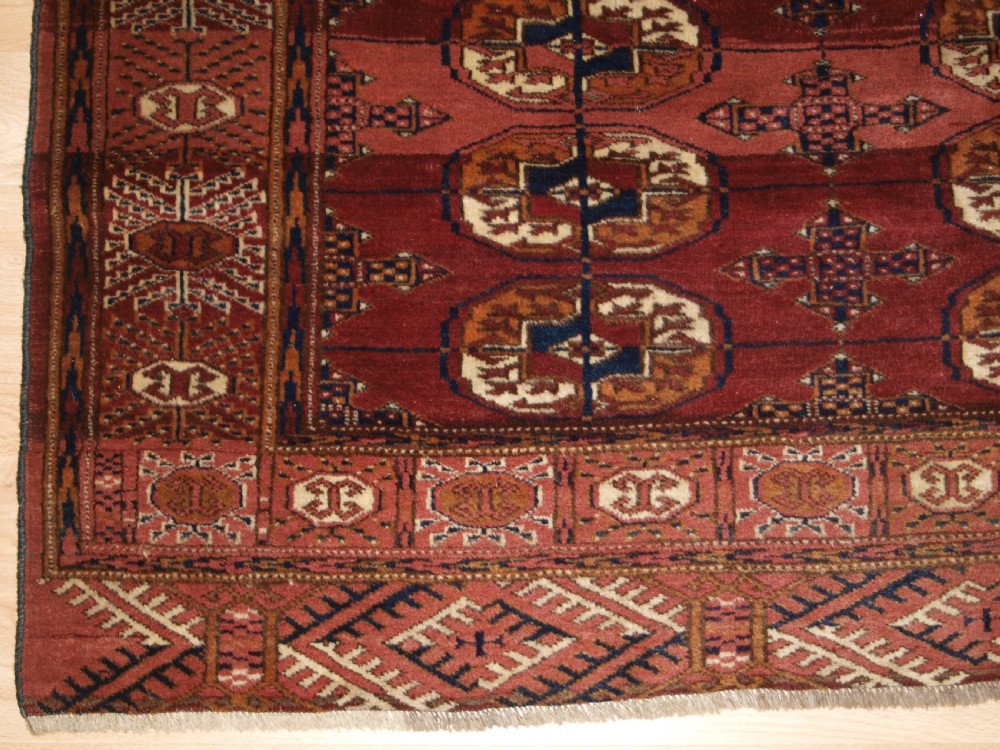 ANTIQUE TEKKE TURKMEN RUG WITH ABRASHED MADDER RED FIELD, CIRCA 1900. View VII