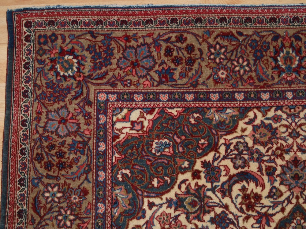 A rectangular hand-knotted Persian Tabriz wool rug with a central dark navy floral medallion on a cream field framed by multi-stripe borders. View II