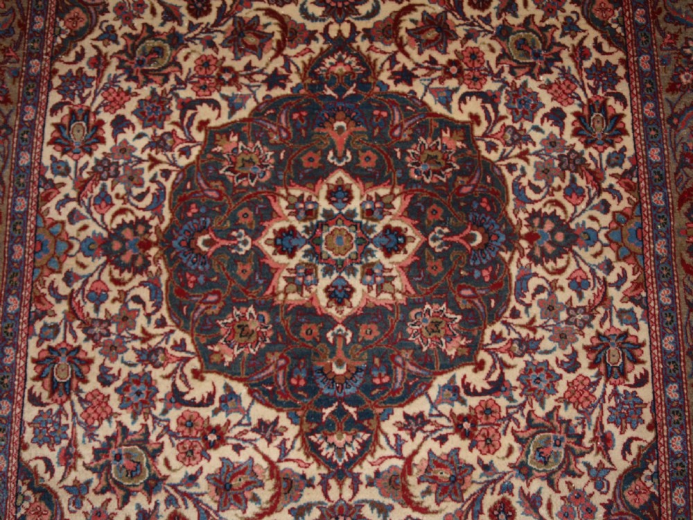 A rectangular hand-knotted Persian Tabriz wool rug with a central dark navy floral medallion on a cream field framed by multi-stripe borders. View VIII