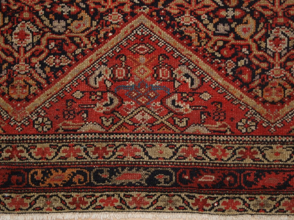 An antique hand-knotted Persian Malayer wool rug featuring an intricate red lattice pattern framed by multi-band decorative borders. View VIII