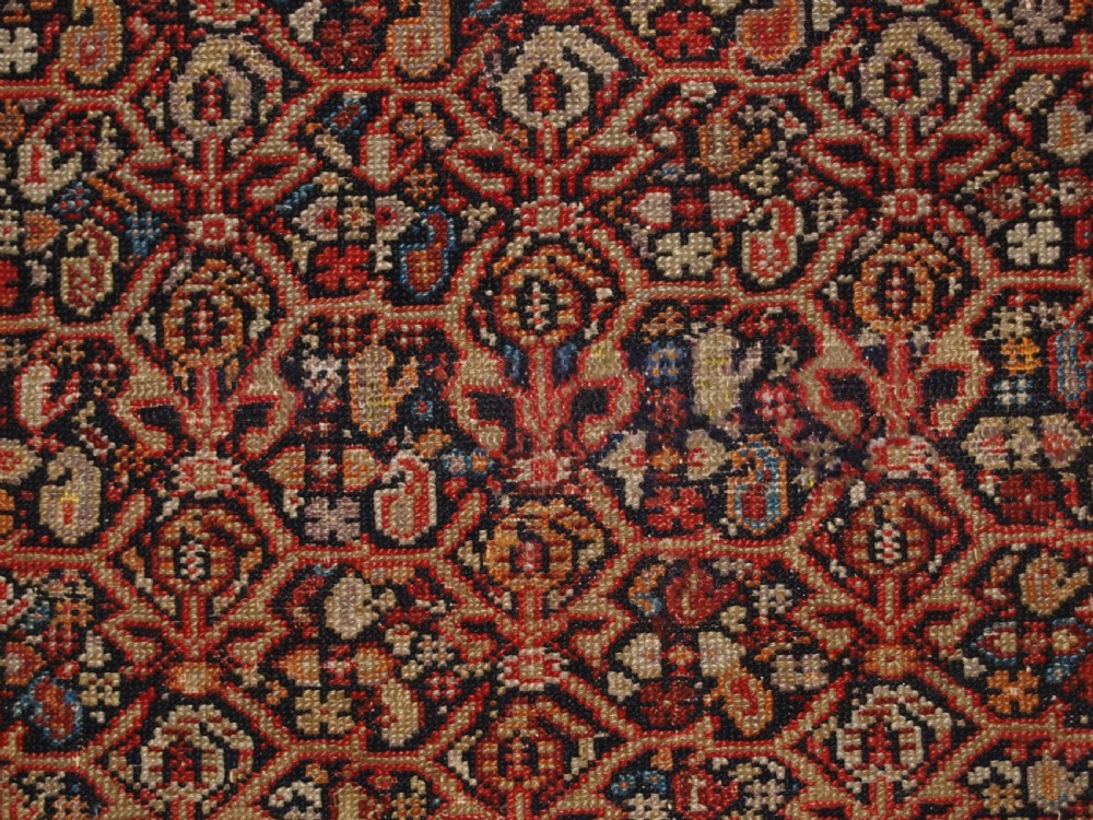An antique hand-knotted Persian Malayer wool rug featuring an intricate red lattice pattern framed by multi-band decorative borders. View X