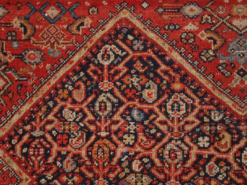 An antique hand-knotted Persian Malayer wool rug featuring an intricate red lattice pattern framed by multi-band decorative borders. View XI
