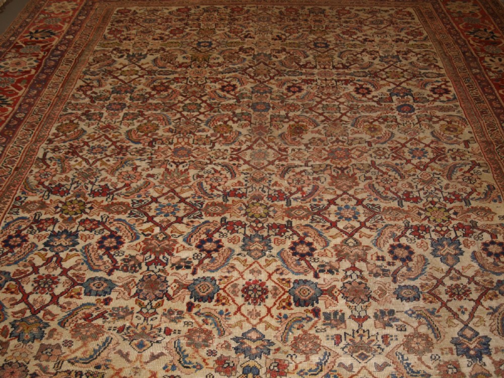 An antique Persian Mahal wool carpet featuring an all-over floral lattice pattern on an ivory ground, framed by a wide terracotta and navy border. View IV