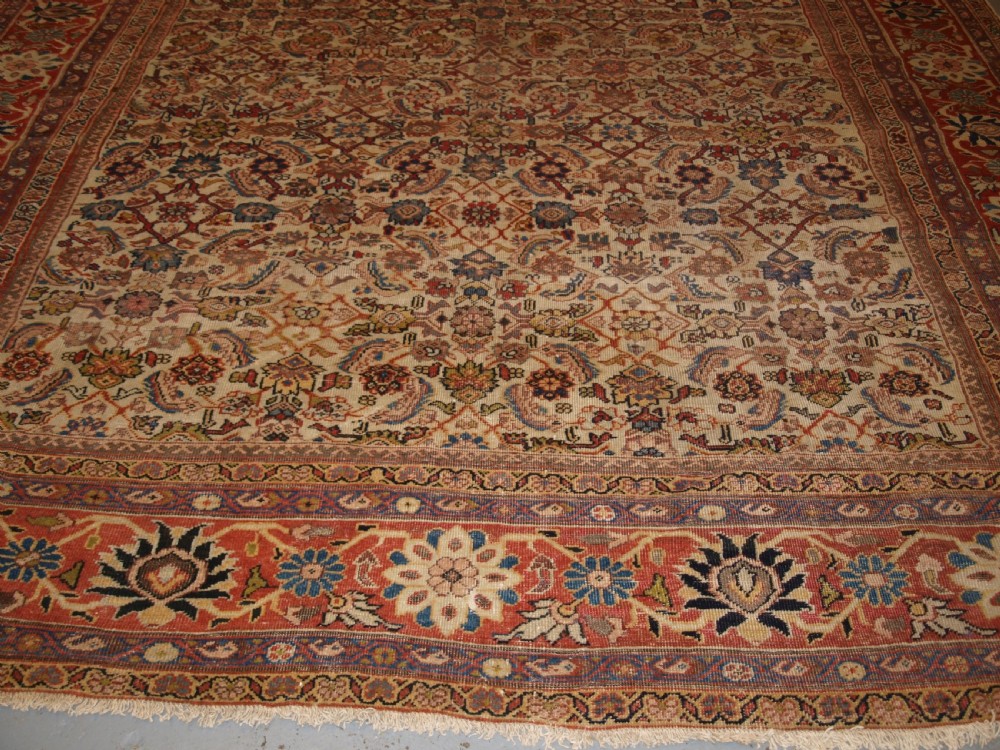 An antique Persian Mahal wool carpet featuring an all-over floral lattice pattern on an ivory ground, framed by a wide terracotta and navy border. View V