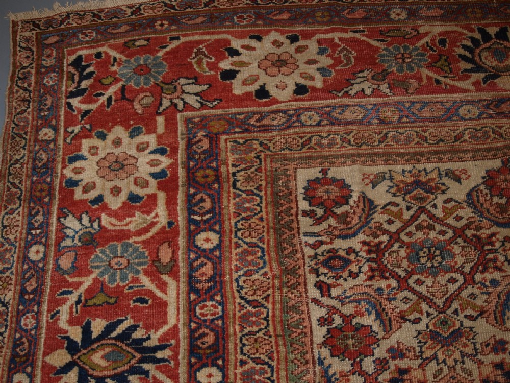 An antique Persian Mahal wool carpet featuring an all-over floral lattice pattern on an ivory ground, framed by a wide terracotta and navy border. View VI