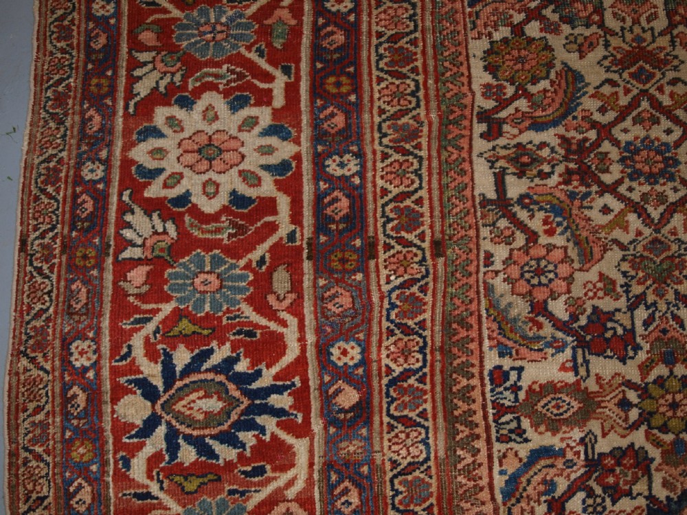 An antique Persian Mahal wool carpet featuring an all-over floral lattice pattern on an ivory ground, framed by a wide terracotta and navy border. View VII