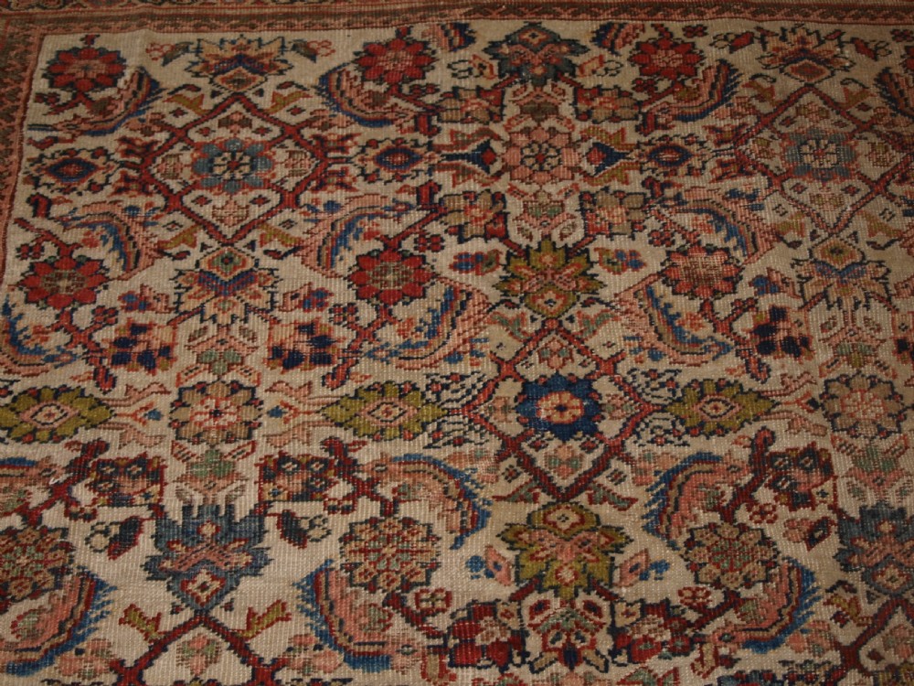 An antique Persian Mahal wool carpet featuring an all-over floral lattice pattern on an ivory ground, framed by a wide terracotta and navy border. View VIII