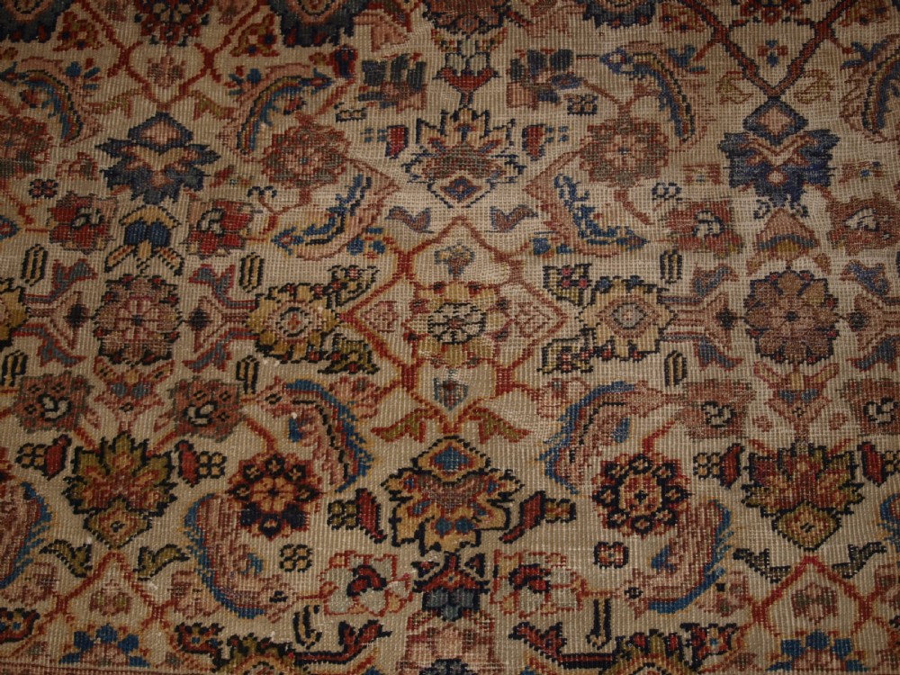 An antique Persian Mahal wool carpet featuring an all-over floral lattice pattern on an ivory ground, framed by a wide terracotta and navy border. View X