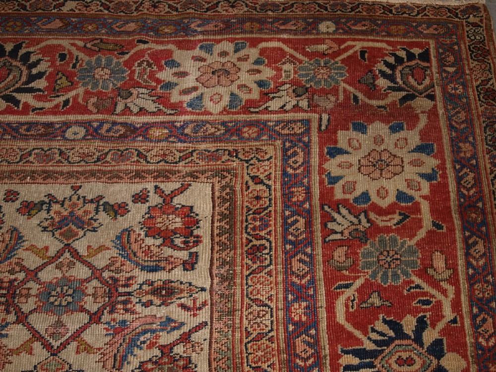An antique Persian Mahal wool carpet featuring an all-over floral lattice pattern on an ivory ground, framed by a wide terracotta and navy border. View XIV