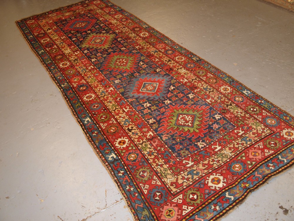 ANTIQUE CAUCASIAN LONG RUG OR RUNNER WITH MEDALLION DESIGN, SUPERB COLOURS, CIRCA 1900.