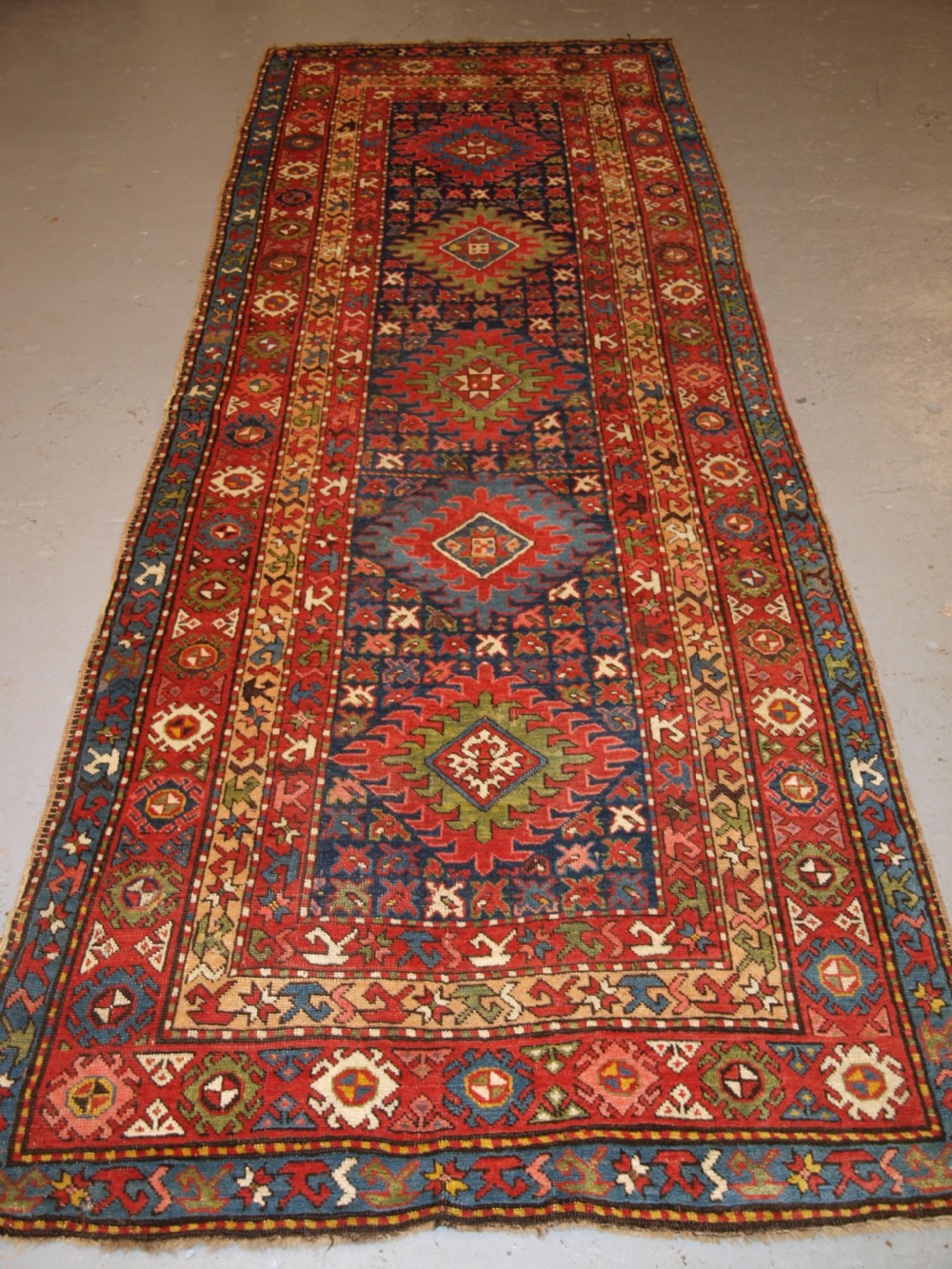 ANTIQUE CAUCASIAN LONG RUG OR RUNNER WITH MEDALLION DESIGN, SUPERB COLOURS, CIRCA 1900. View II