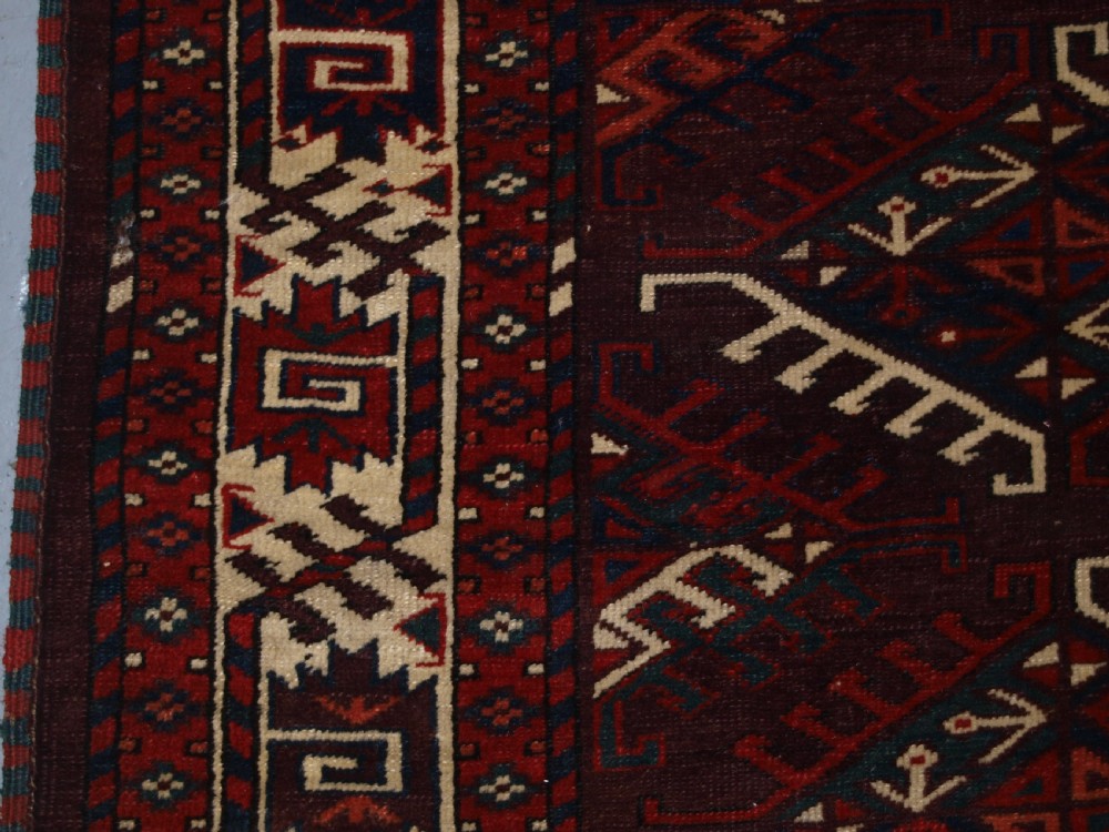 ANTIQUE YOMUT TURKMEN MAIN CARPET WITH DYRNAK GUL DESIGN, CURL LEAF BORDER, CIRCA 1880. View III