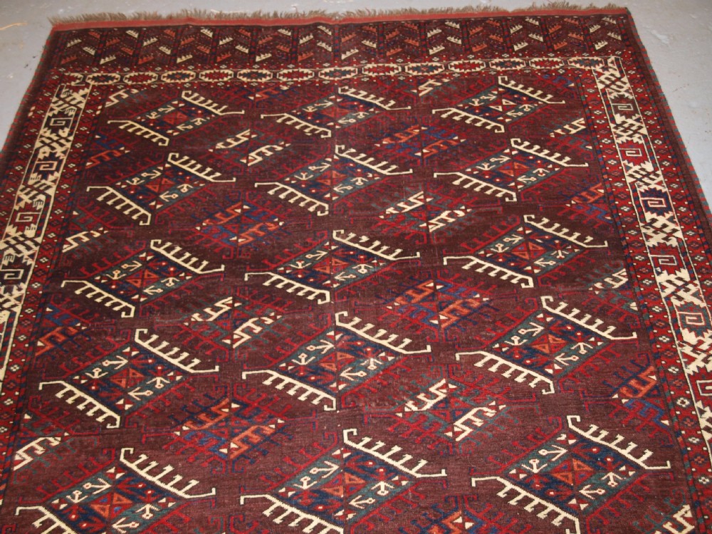 ANTIQUE YOMUT TURKMEN MAIN CARPET WITH DYRNAK GUL DESIGN, CURL LEAF BORDER, CIRCA 1880. View IV