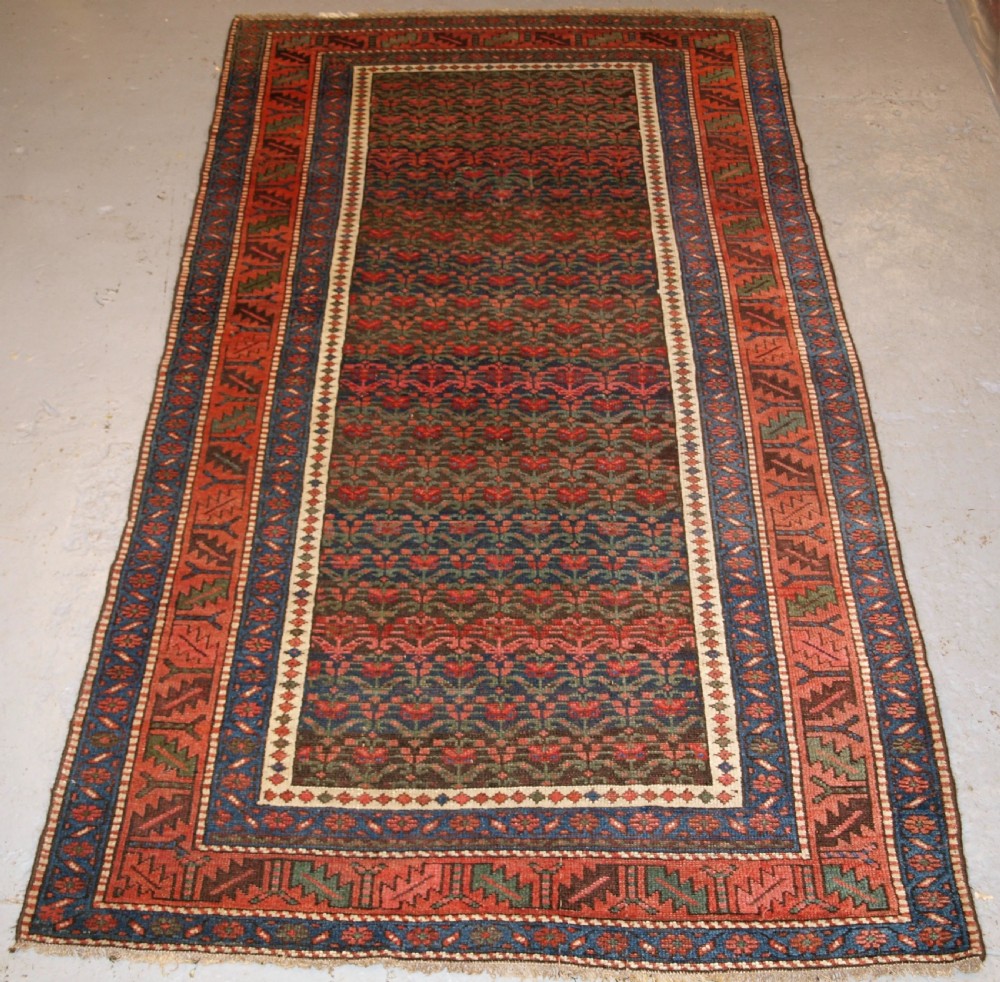 ANTIQUE KURDISH LONG RUG WITH ALL OVER SHRUB DESIGN, LATE 19TH CENTURY.