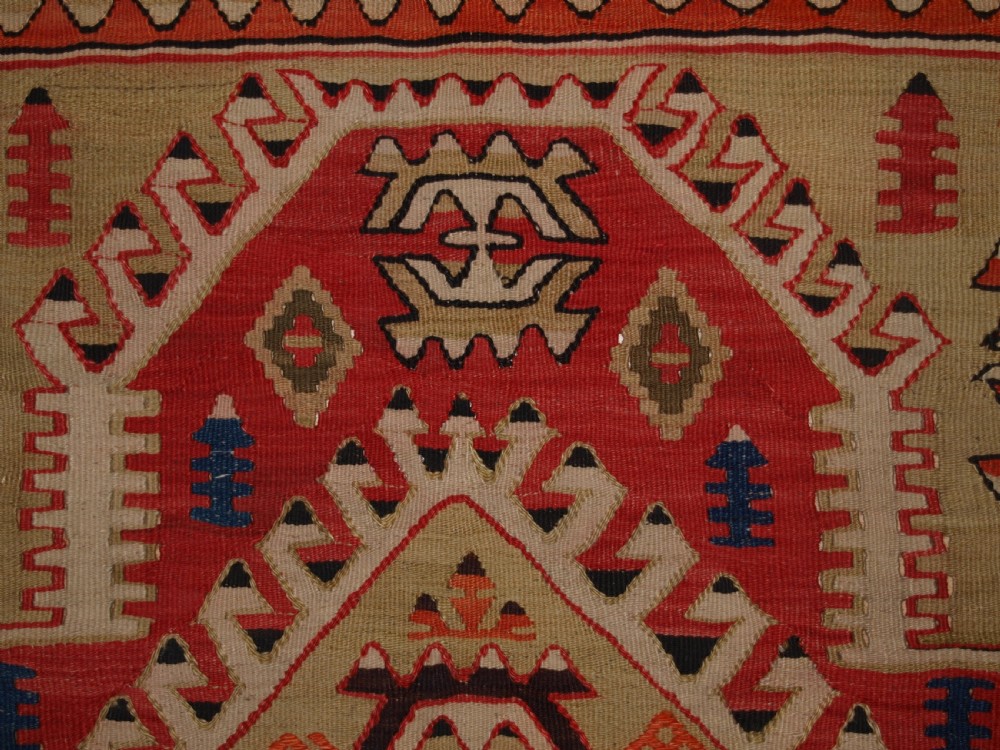 An antique Turkish Konya flatweave prayer kilim featuring a stepped mihrab pattern in red, blue, terracotta, and beige wool. View VII