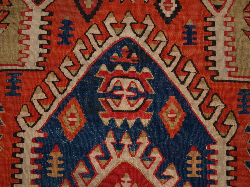 An antique Turkish Konya flatweave prayer kilim featuring a stepped mihrab pattern in red, blue, terracotta, and beige wool. View VIII