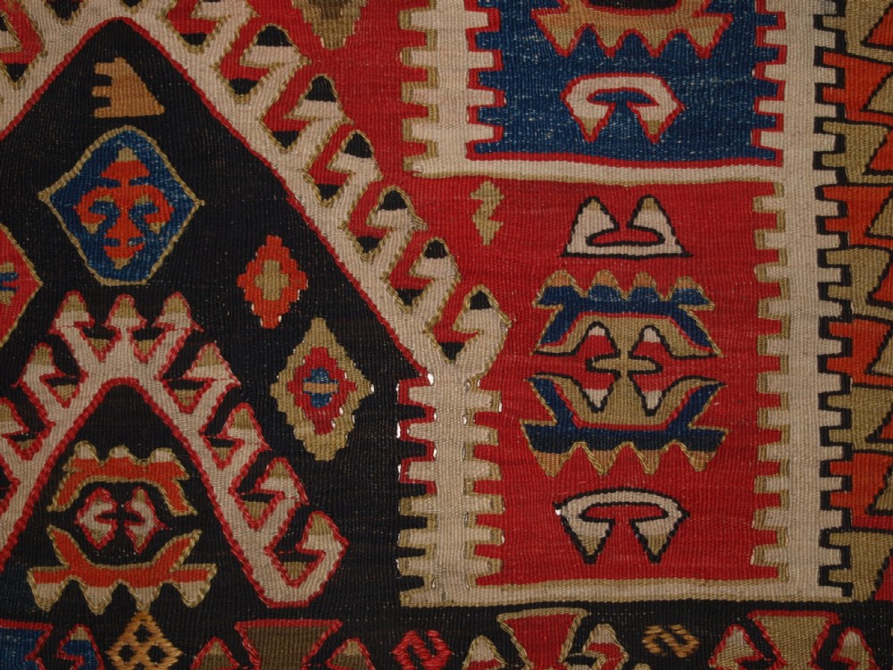 An antique Turkish Konya flatweave prayer kilim featuring a stepped mihrab pattern in red, blue, terracotta, and beige wool. View IX