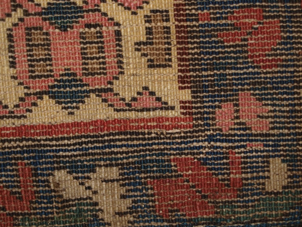 An antique 19th-century Caucasian Karabagh hallway runner carpet featuring colourful repeated boteh motifs across a dark central field framed by ivory geometric borders. View XI