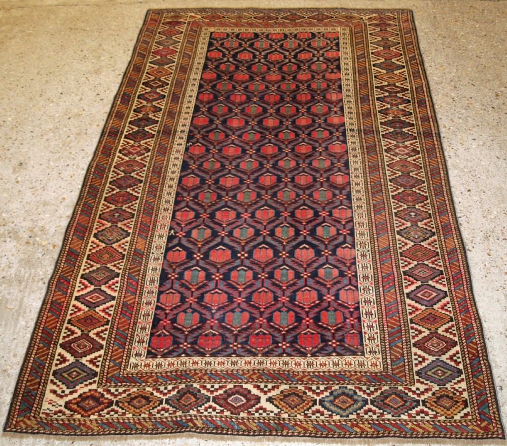 ANTIQUE CAUCASIAN SHIRVAN RUG WITH LATTICE DESIGN FILLED WITH TULIPS, LATE 19TH CENTURY.