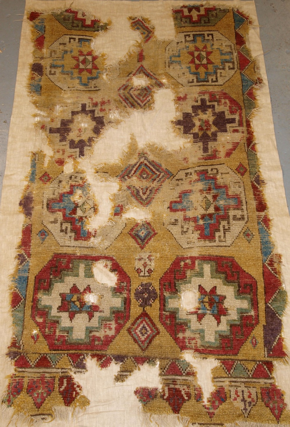 ANTIQUE MOUNTED FRAGMENT OF TURKISH KONYA LONG RUG WITH MEMLINC GULS, 1ST HALF 18TH CENTURY.