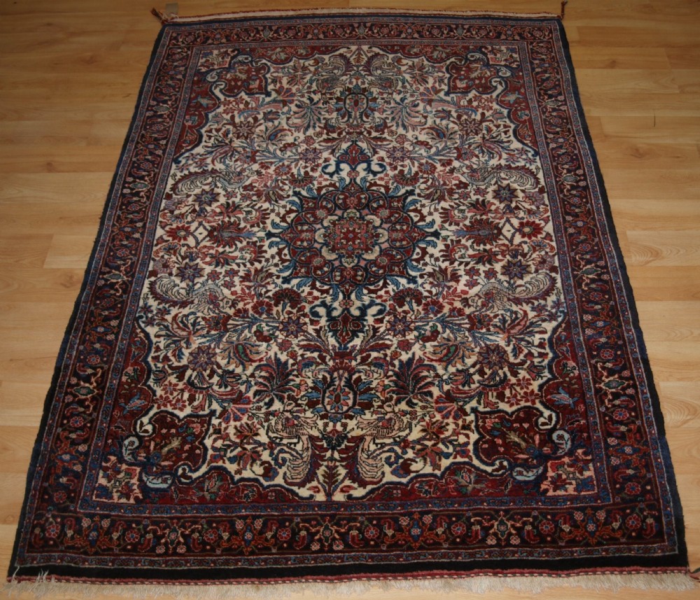 OLD PERSIAN BIJAR RUG, IVORY GROUND WITH FLORAL DESIGN, CIRCA 1920/30.