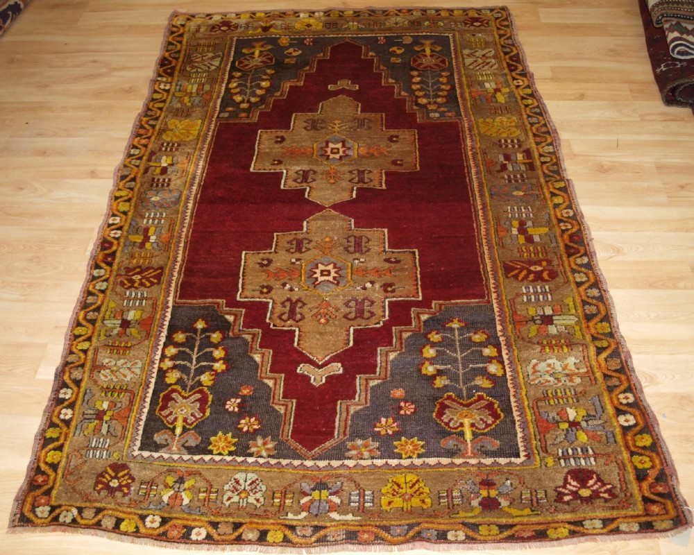ANTIQUE TURKISH MADEN REGION RUG, DOUBLE MEDALLION, RED GROUND, CIRCA 1900.
