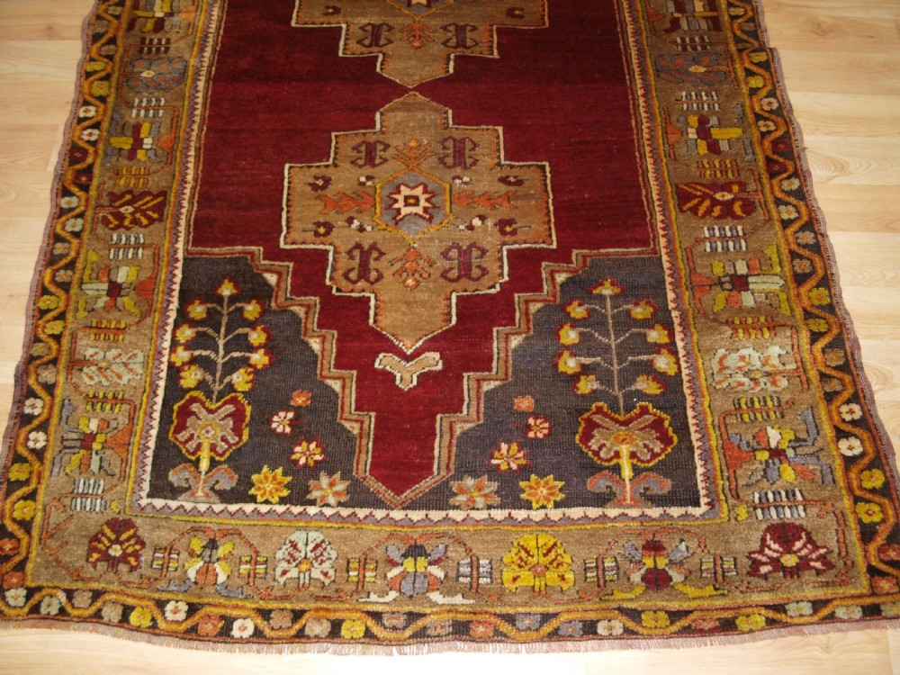 ANTIQUE TURKISH MADEN REGION RUG, DOUBLE MEDALLION, RED GROUND, CIRCA 1900. View VI