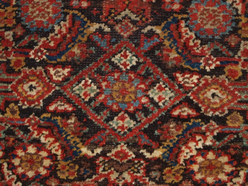 An antique hand-knotted Malayer rug displaying a detailed dark navy and red Herati lattice pattern framed by an ivory floral border. View VIII
