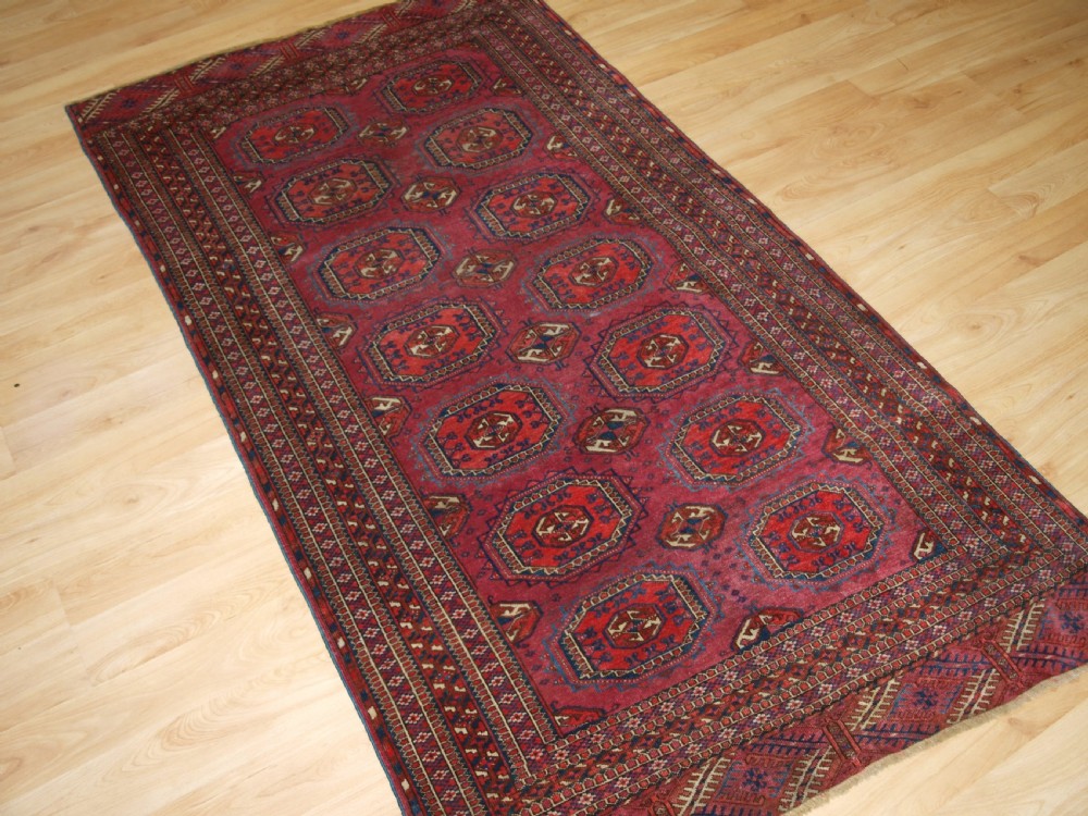 ANTIQUE TEKKE TURKMEN RUG WITH SALOR GULS, COCHINEAL COLOUR, CIRCA 1890. View II
